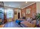 Inviting living room featuring a stylish exposed brick wall and comfortable seating arrangement at 1739 E Martin Luther King Jr Blvd, Denver, CO 80205