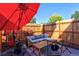 Outdoor patio space with comfortable seating, shaded by a large red umbrella at 1739 E Martin Luther King Jr Blvd, Denver, CO 80205