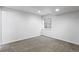 Spacious basement bedroom with plush carpeting and a window at 4727 Raven Run, Broomfield, CO 80023