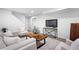 Finished basement Gathering room with comfortable seating and a large TV at 4727 Raven Run, Broomfield, CO 80023