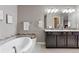 Bathroom features a double vanity and a large soaking tub at 4727 Raven Run, Broomfield, CO 80023