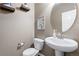 Small bathroom with pedestal sink and toilet at 4727 Raven Run, Broomfield, CO 80023