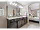 Double vanity bathroom with access to the bedroom at 4727 Raven Run, Broomfield, CO 80023