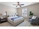 Spacious bedroom with a queen bed and sitting area at 4727 Raven Run, Broomfield, CO 80023