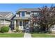 Attractive two-story townhome with stone accents and landscaped front yard at 4727 Raven Run, Broomfield, CO 80023