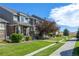 Townhome community with sidewalks and green space at 4727 Raven Run, Broomfield, CO 80023