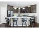 Modern kitchen with dark cabinets, granite countertops and island at 4727 Raven Run, Broomfield, CO 80023