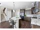 Modern kitchen featuring dark wood cabinets and granite countertops at 4727 Raven Run, Broomfield, CO 80023