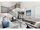 Open living room with a view of the kitchen and staircase at 4727 Raven Run, Broomfield, CO 80023