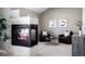 Cozy sitting area with fireplace and two armchairs at 4727 Raven Run, Broomfield, CO 80023