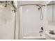Bathroom with a white shower curtain and a chrome shower head attached to the tiled shower walls at 4882 E Kentucky Ave # A, Denver, CO 80246