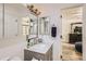 A bathroom vanity features a framed mirror, cabinet, sink, and chrome faucet and hardware at 4882 E Kentucky Ave # A, Denver, CO 80246