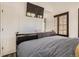 A primary bedroom featuring natural light and a wall-mounted TV for relaxing entertainment at 4882 E Kentucky Ave # A, Denver, CO 80246