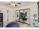 This bedroom features built-in shelving for storage, and a large mirrored closet at 4882 E Kentucky Ave # A, Denver, CO 80246