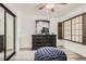 This bedroom features a black dresser with a framed mirror on top and natural light at 4882 E Kentucky Ave # A, Denver, CO 80246