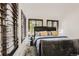 Serene bedroom with stylish shutters, wood-look flooring, and a comfortable bed at 4882 E Kentucky Ave # A, Denver, CO 80246