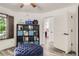 This bedroom features built-in shelving for storage, and a view into an adjacent room at 4882 E Kentucky Ave # A, Denver, CO 80246
