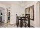 Charming dining area with modern chandelier and plantation shutters at 4882 E Kentucky Ave # A, Denver, CO 80246