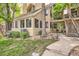Charming condo building with a private entrance and mature landscaping at 4882 E Kentucky Ave # A, Denver, CO 80246