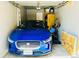 Garage featuring a blue car with storage behind it as well as natural and artificial light at 4882 E Kentucky Ave # A, Denver, CO 80246