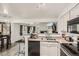 Cozy kitchen featuring sleek appliances, granite countertops, and a breakfast bar overlooking the living area at 4882 E Kentucky Ave # A, Denver, CO 80246