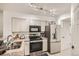 Well-lit kitchen featuring stainless steel appliances, granite countertops, and ample cabinet space at 4882 E Kentucky Ave # A, Denver, CO 80246