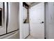 A laundry room featuring a stacked washer and dryer, as well as extra storage space at 4882 E Kentucky Ave # A, Denver, CO 80246