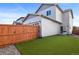 Artificial turf backyard with wooden fence and home at 6792 Longpark Dr, Parker, CO 80138