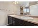 Double vanity bathroom with dark brown cabinets at 6792 Longpark Dr, Parker, CO 80138