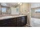 Double vanity bathroom with dark brown cabinets at 6792 Longpark Dr, Parker, CO 80138