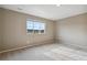 Bright bedroom featuring neutral walls and carpeted floors at 6792 Longpark Dr, Parker, CO 80138