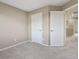 Simple bedroom with carpet, two doors, and neutral walls at 6792 Longpark Dr, Parker, CO 80138