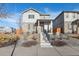 Two-story house with gray siding, stone accents, and a landscaped front yard at 6792 Longpark Dr, Parker, CO 80138