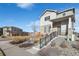 Two-story house with gray siding, stone accents, and a landscaped front yard at 6792 Longpark Dr, Parker, CO 80138