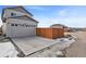 Two-car garage with driveway and wooden fence at 6792 Longpark Dr, Parker, CO 80138