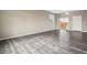 Living room with gray wood-look flooring and sliding glass door at 6792 Longpark Dr, Parker, CO 80138