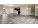 Open concept living space with gray flooring and kitchen views at 6792 Longpark Dr, Parker, CO 80138