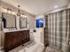 Upscale bathroom featuring double vanity, tub, walk-in shower and modern fixtures at 9412 Burgundy Cir, Highlands Ranch, CO 80126