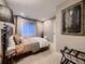 Cozy bedroom features plush carpet, large window, and neutral paint colors at 9412 Burgundy Cir, Highlands Ranch, CO 80126