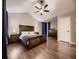 Large bedroom has wood floors, vaulted ceiling, fan, and a bed with wood frame at 9412 Burgundy Cir, Highlands Ranch, CO 80126