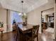 Bright dining room featuring a rustic wooden table, decorative chandelier, and natural light at 9412 Burgundy Cir, Highlands Ranch, CO 80126