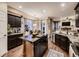 Spacious kitchen with stainless steel appliances, granite countertops, and a large center island at 9412 Burgundy Cir, Highlands Ranch, CO 80126