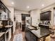Well-equipped kitchen featuring dark cabinets, stainless steel appliances, and granite countertops at 9412 Burgundy Cir, Highlands Ranch, CO 80126
