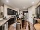 Modern kitchen features dark cabinetry, stainless steel appliances, granite countertops and a kitchen island at 9412 Burgundy Cir, Highlands Ranch, CO 80126