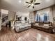 Open-concept living room with hardwood floors, abundant natural light, and comfortable seating at 9412 Burgundy Cir, Highlands Ranch, CO 80126