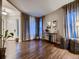 Spacious living room features large windows, hardwood floors, and neutral decor at 9412 Burgundy Cir, Highlands Ranch, CO 80126