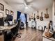Spacious office with hardwood floors, guitars mounted on the wall, and a ceiling fan at 9412 Burgundy Cir, Highlands Ranch, CO 80126