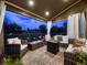 Inviting outdoor living space with a covered patio, comfortable seating, and a cozy fireplace at 9412 Burgundy Cir, Highlands Ranch, CO 80126