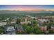 Beautiful aerial view showcases an educational campus, and rolling mountains in the distance under a vibrant sunset sky at 2340 S Columbine St, Denver, CO 80210