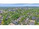 Lush green neighborhood with tree-lined streets and diverse architecture in an aerial view of the community and city skyline at 2340 S Columbine St, Denver, CO 80210